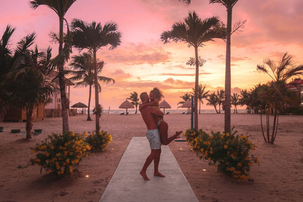 couple on beach pink sunset Brisa Oceano resort belize