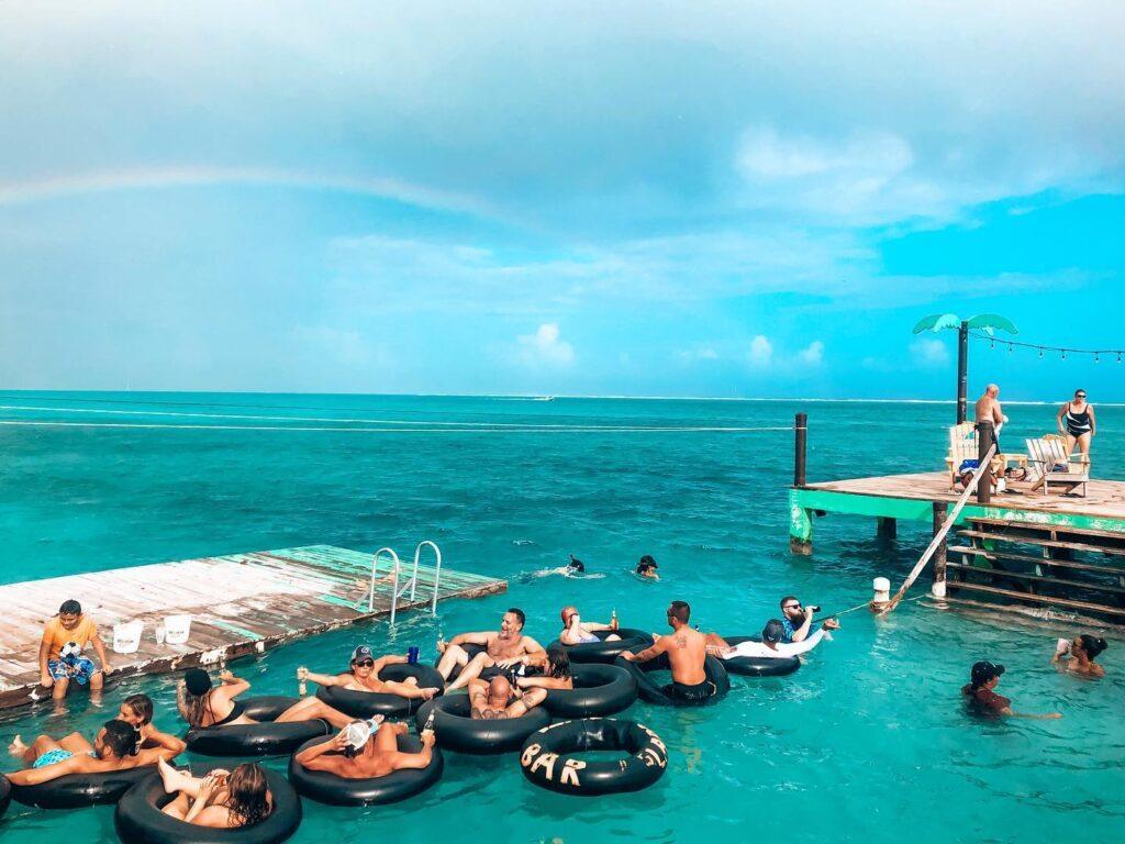 Serving up Belikins by inner tube at Palapa Bar & Grill. Photo courtesy Roeming Belize
