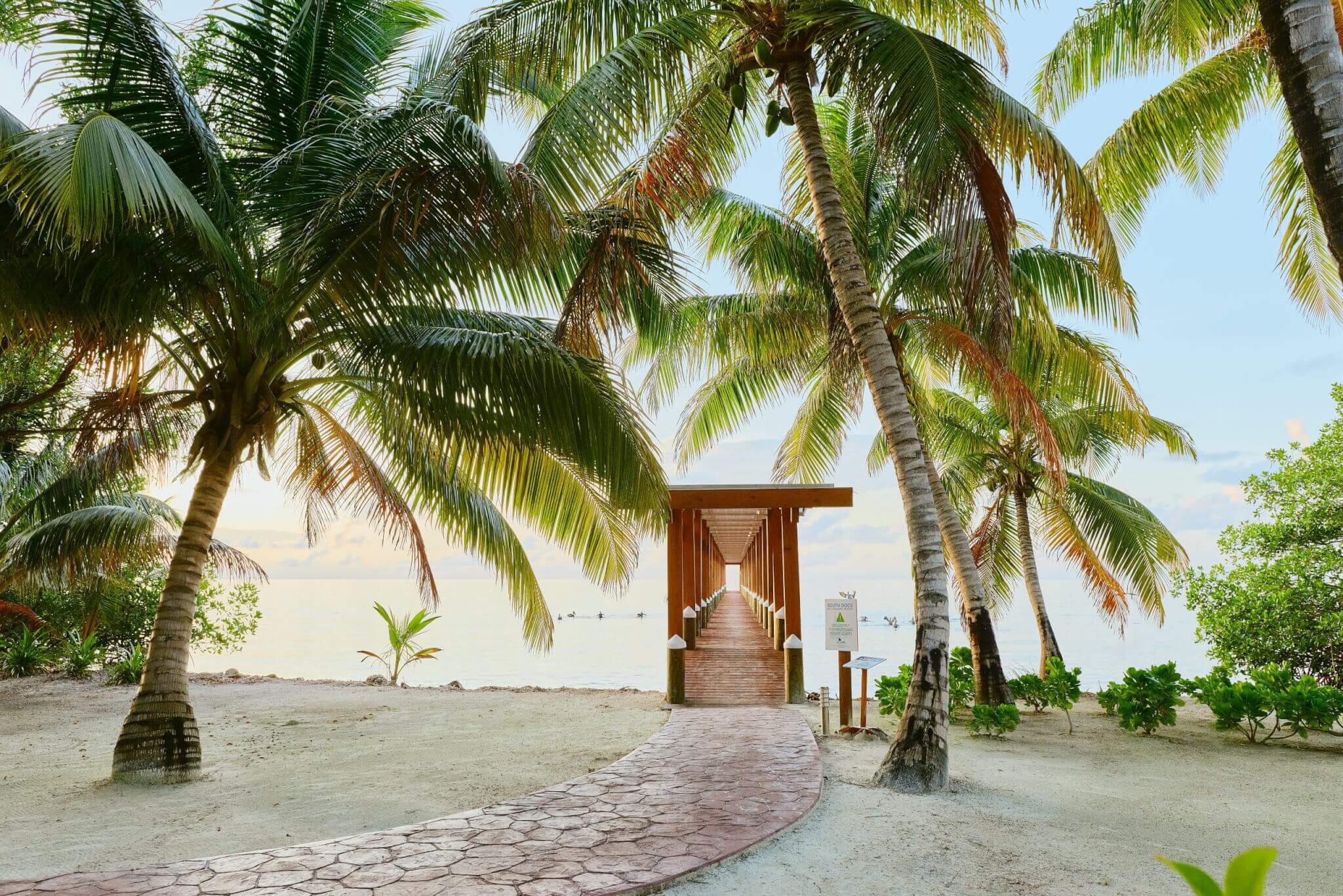 vacation-private-island-ray-caye-dock-sunrise-belize